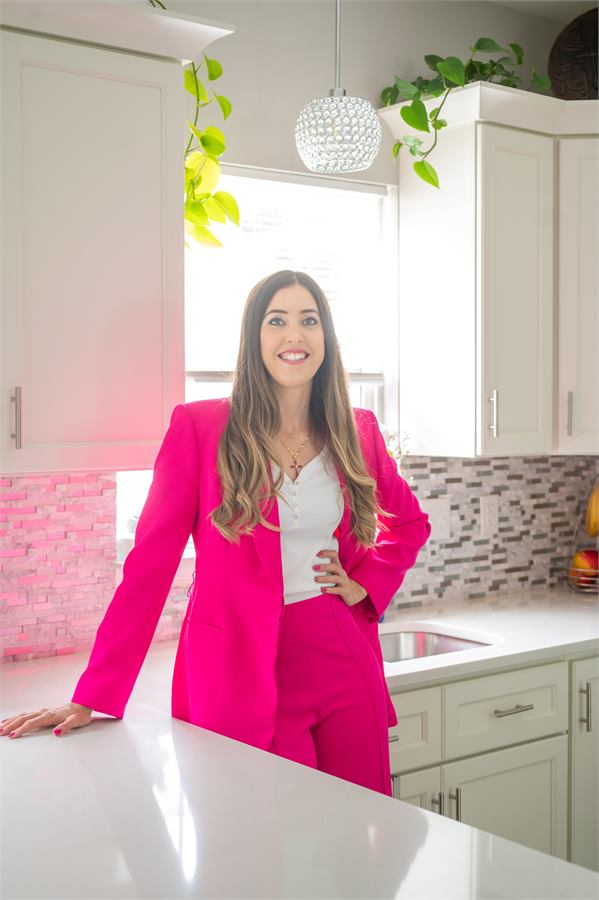 Thais, owner of Pro Shine Cleaning Services, in a kitchen